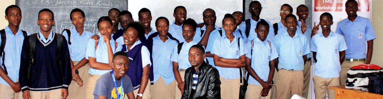 Group of students and caregivers in a school classroom during educational activities